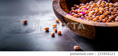 Extreme close-up macro view of raw fonio grains in a wooden bowl showcasing texture and detail Extreme close-up macro view of raw fonio grains in a wooden bowl showcasing texture and detail 125958121