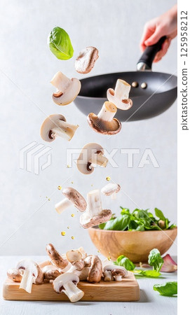 Motion capture of wild mushrooms in oil, creating a vibrant culinary moment Motion capture of wild mushrooms in oil, creating a vibrant culinary moment 125958212