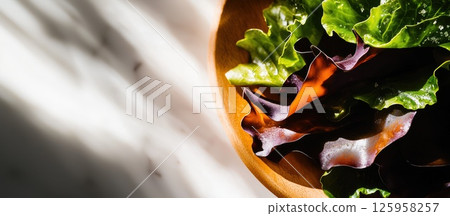 Crispy seaweed chips showcasing delicate textures and salt crystals in warm light Crispy seaweed chips showcasing delicate textures and salt crystals in warm light 125958257