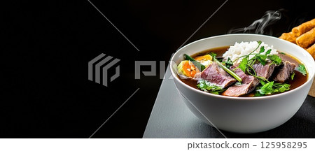 Experience the warmth of Bak Kut Teh with its aromatic broth and tender meat 125958295