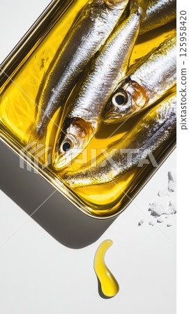 Golden olive oil surrounding fresh sardines, highlighting clean marine protein. Sparkling sea salt crystals enhancing natural seafood flavor and culinary simplicity Golden olive oil surrounding fresh sardines, highlighting clean marine protein. Sparkling sea salt crystals enhancing natural seafood flavor and culinary simplicity 125958420