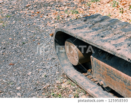 Old caterpillar tracks of a small excavator 125958593