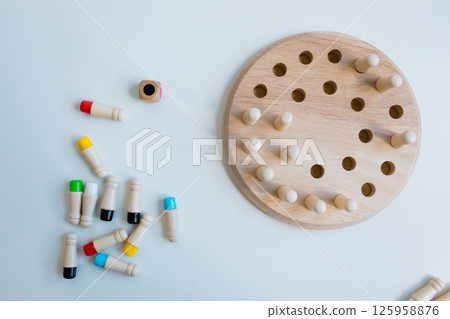 Wooden strategy puzzle with pegs and board for brain training Wooden strategy puzzle with pegs and board for brain training 125958876