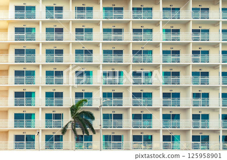 Modern hotel with rows of balconies creates a geometric pattern. Modern hotel with rows of balconies creates a geometric pattern. 125958901