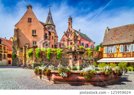 Eguisheim, Alsace, France. Picturesque village with colorful half-timbered houses, cobblestone streets and flower-filled balconies. 125959024