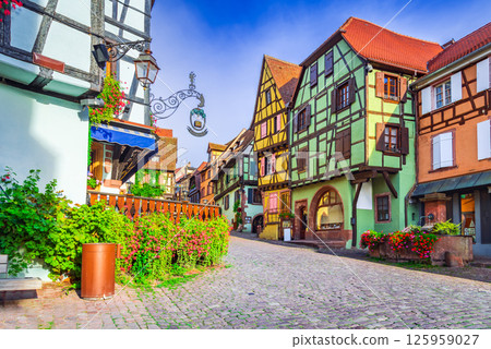 Riquewihr is a charming medieval Alsace village in France, known for its half-timbered houses, vineyards and cobblestone streets. Riquewihr is a charming medieval Alsace village in France, known for its half-timbered houses, vineyards and cobblestone streets. 125959027