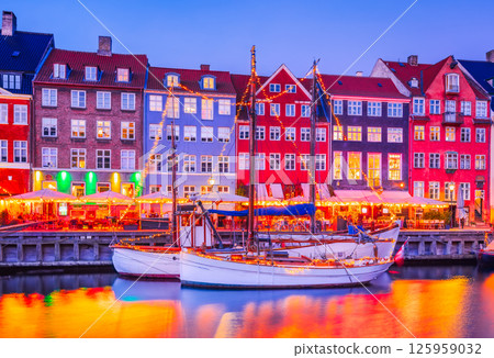 Copenhagen, Denmark. Nyhavn, Kobenhavn's iconic canal, colorful night water reflection. 125959032