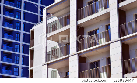Modern new residential apartment house building complex. Exterior view of modern apartment building. New construction apartment or condo complex. Modern new residential apartment house building complex. Exterior view of modern apartment building. New construction apartment or condo complex. 125959447