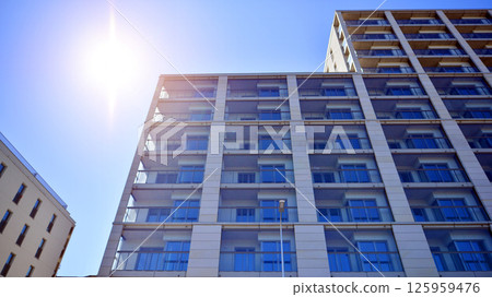 Modern new residential apartment house building complex. Exterior view of modern apartment building. New construction apartment or condo complex. 125959476