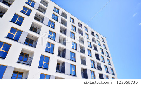 Modern new residential apartment house building complex. Exterior view of modern apartment building. New construction apartment or condo complex. 125959739