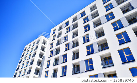 Modern new residential apartment house building complex. Exterior view of modern apartment building. New construction apartment or condo complex. 125959740