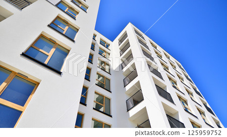 Modern new residential apartment house building complex. Exterior view of modern apartment building. New construction apartment or condo complex. 125959752