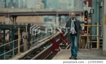 Businessman walking on Manhattan train station platform in New York City 125959991