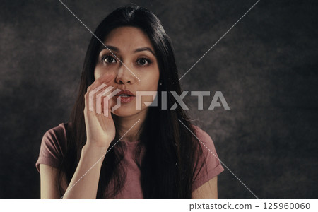 Young woman whispering gossiping sharing secrets with hand near mouth Young woman whispering gossiping sharing secrets with hand near mouth 125960060