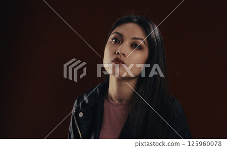 Young asian woman wearing leather jacket and burgundy lipstick 125960078