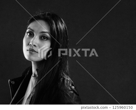 Thoughtful Woman in Dramatic Black and White Portrait 125960150