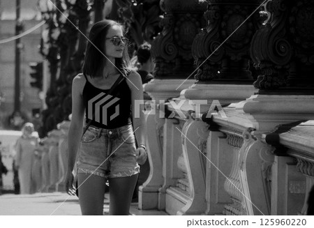Young woman walking on Alexandre III bridge in Paris Young woman walking on Alexandre III bridge in Paris 125960220