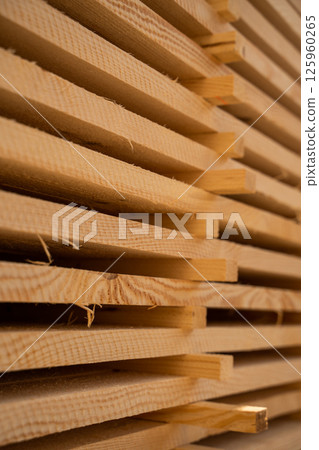 Angled side view of timber stack showing textured plank edges 125960265