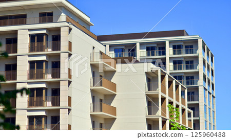 Modern new residential apartment house building complex. Exterior view of modern apartment building. New construction apartment or condo complex. Modern new residential apartment house building complex. Exterior view of modern apartment building. New construction apartment or condo complex. 125960488