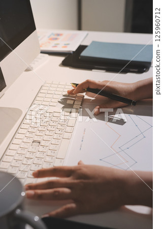 Expert woman asian female people review data number costing managerial account prepare monthly actual cost variance report at tax audit office. ESG sheet budget control ERP process service project. 125960712