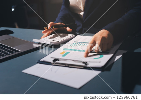 Expert woman asian female people review data number costing managerial account prepare monthly actual cost variance report at tax audit office. ESG sheet budget control ERP process service project. 125960761