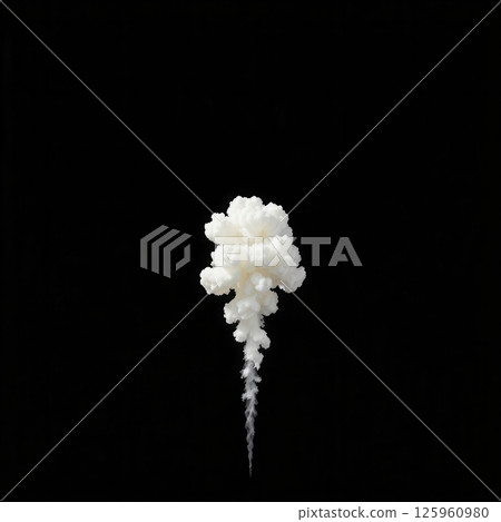 Dramatic fluffy white smoke explosion burst with trailing wisps on dark black background 125960980