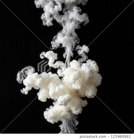 Dramatic fluffy white smoke explosion burst with trailing wisps on dark black background 125960981