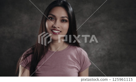 Young Southeast Asian Woman Smiling on Dark Background 125961115
