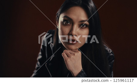 Woman in deep thought with a serious expression 125961117
