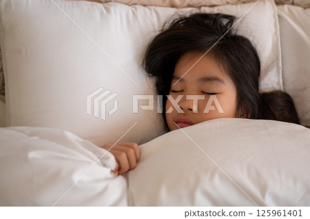 女孩將臉埋在白色枕頭里安然入睡的可愛表情令人印象深刻。 125961401