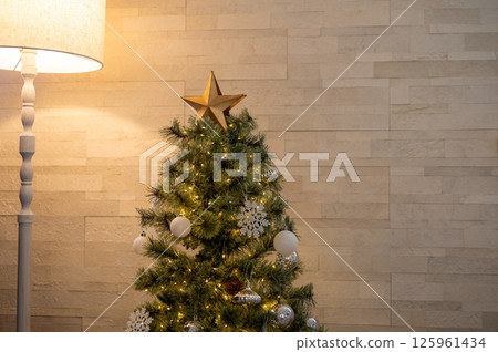 The interior decoration with lights and Christmas trees on the wall warms up the space. The interior decoration with lights and Christmas trees on the wall warms up the space. 125961434