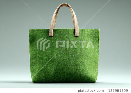 Reusable shopping bag made of fabric of green color on a white background. 125961509