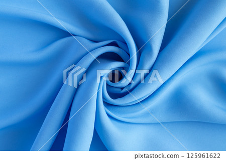 Close-up of vibrant blue fabric with creative folds and unique textures 125961622