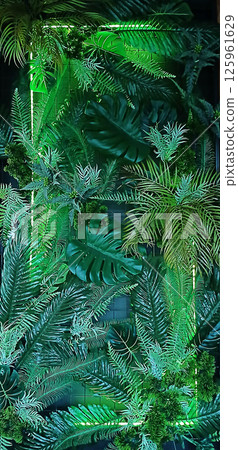 Vibrant green tropical plants with exotic leaves forming a lush backdrop Vibrant green tropical plants with exotic leaves forming a lush backdrop 125961629