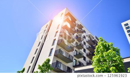 Eco apartment building saving energy and fresh air. Modern block of flats in green area, residential apartment and luxury house complex.  125961923