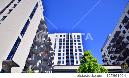 Eco apartment building saving energy and fresh air. Modern block of flats in green area, residential apartment and luxury house complex. Eco apartment building saving energy and fresh air. Modern block of flats in green area, residential apartment and luxury house complex. 125961924