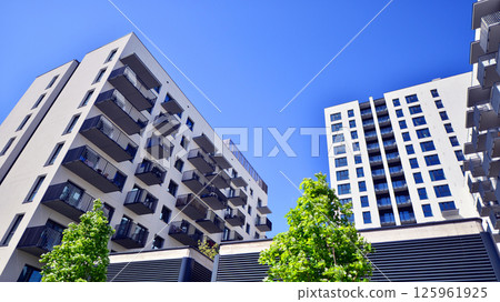 Eco apartment building saving energy and fresh air. Modern block of flats in green area, residential apartment and luxury house complex. Eco apartment building saving energy and fresh air. Modern block of flats in green area, residential apartment and luxury house complex. 125961925