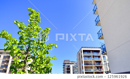 Eco apartment building saving energy and fresh air. Modern block of flats in green area, residential apartment and luxury house complex.  125961926