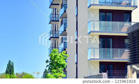 Eco apartment building saving energy and fresh air. Modern block of flats in green area, residential apartment and luxury house complex.  125961928