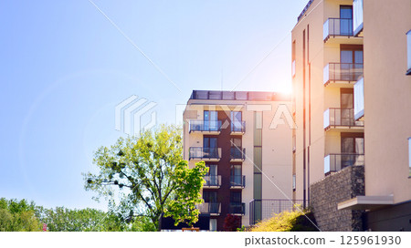 Eco apartment building saving energy and fresh air. Modern block of flats in green area, residential apartment and luxury house complex.  125961930