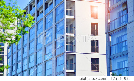 Eco apartment building saving energy and fresh air. Modern block of flats in green area, residential apartment and luxury house complex.  125961933
