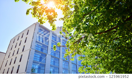 Eco apartment building saving energy and fresh air. Modern block of flats in green area, residential apartment and luxury house complex.  125961952