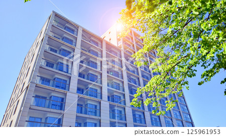 Eco apartment building saving energy and fresh air. Modern block of flats in green area, residential apartment and luxury house complex.  125961953