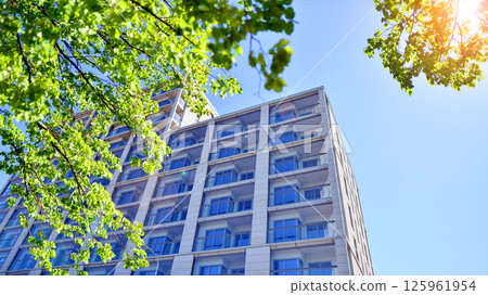 Eco apartment building saving energy and fresh air. Modern block of flats in green area, residential apartment and luxury house complex. Eco apartment building saving energy and fresh air. Modern block of flats in green area, residential apartment and luxury house complex. 125961954
