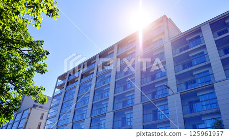 Eco apartment building saving energy and fresh air. Modern block of flats in green area, residential apartment and luxury house complex.  125961957