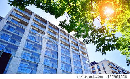 Eco apartment building saving energy and fresh air. Modern block of flats in green area, residential apartment and luxury house complex. Eco apartment building saving energy and fresh air. Modern block of flats in green area, residential apartment and luxury house complex. 125961958