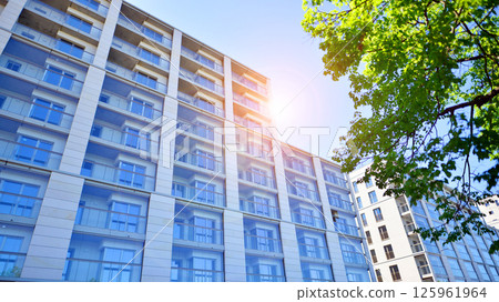 Eco apartment building saving energy and fresh air. Modern block of flats in green area, residential apartment and luxury house complex.  125961964