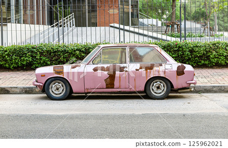 abandoned old rusty car on the side of the road. abandoned old rusty car on the side of the road. 125962021