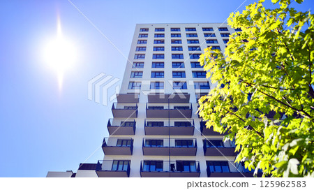 Eco apartment building saving energy and fresh air. Modern block of flats in green area, residential apartment and luxury house complex.  125962583