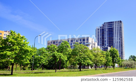 Eco apartment building saving energy and fresh air. Modern block of flats in green area, residential apartment and luxury house complex.  125962588